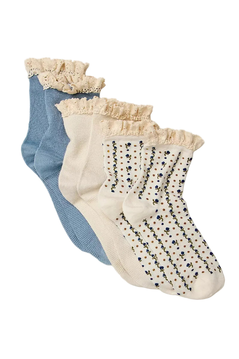 Trestles Clothing Company ruffle sock pack featuring blue, cream, and floral waffle knit crew socks with lace trim.